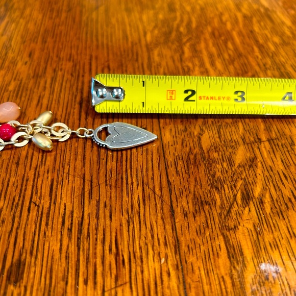 Chico’s 34 in charm necklace tag still attached. Charms include heart, star, etc - Picture 7 of 7
